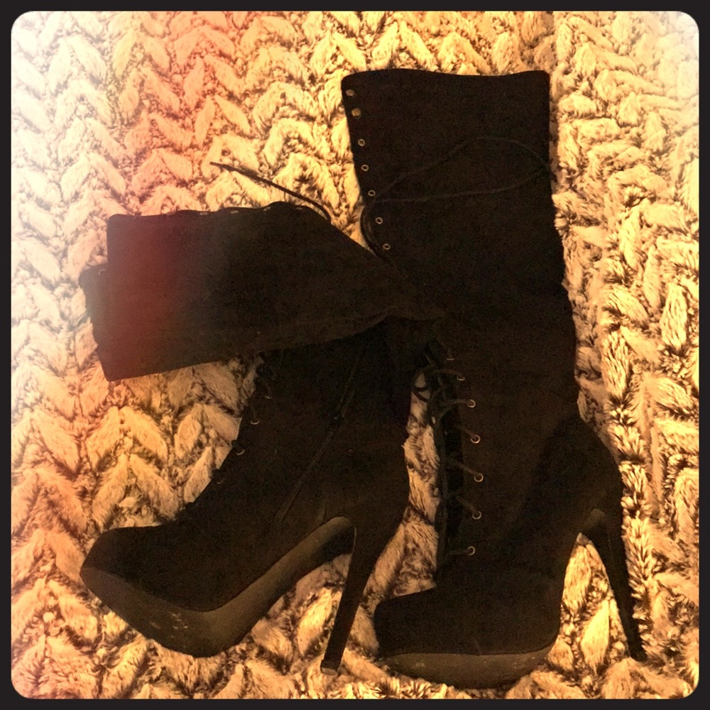 Knee length black suede boots.